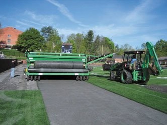 FieldTurf's Green Machine that is used to remove rolls of artificial turf and the infill