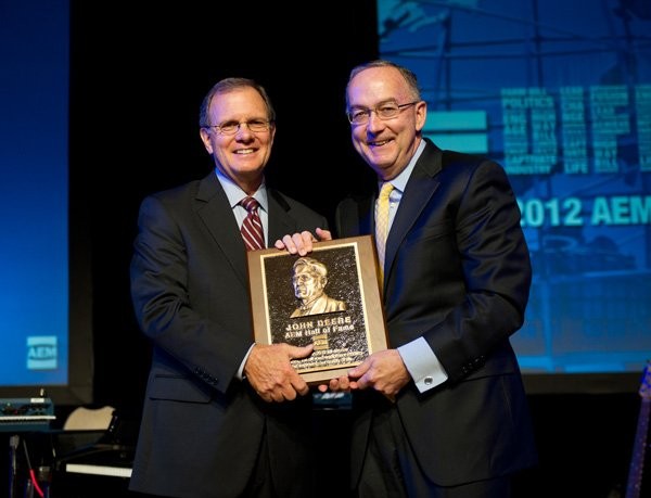 Deere &amp; Company Chairman and Chief Executive Officer, Sam Allen accepts the AEM Hall of Fame plaque from 2012 Chair of the AEM and CEO of Krone, North America, Rusty Fowler.
