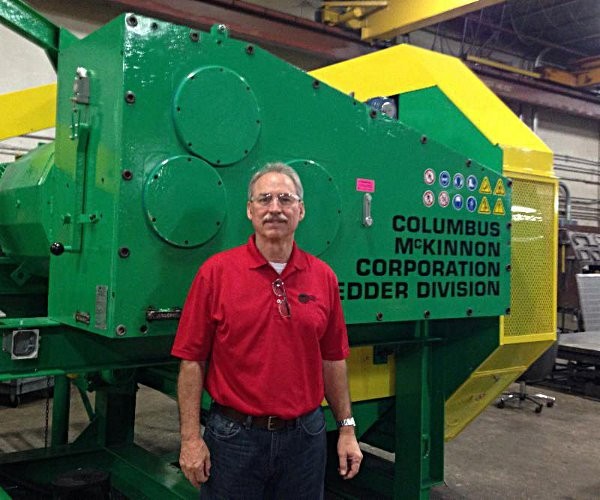 Robert Perron, President of GWC, standing with the CM Dual Speed Tire Shredder during a  recent visit to the CM factory in Sarasota, Florida