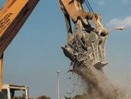 Concrete crusher removes and cuts rebar