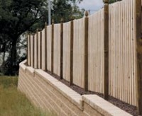 Pre-engineered system for building fence-ready retaining walls