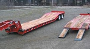Trailers for hauling paving equipment