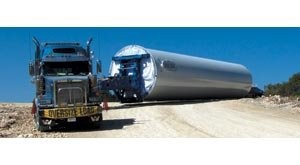 Long-time trucker uses custom-built twin-steer, tri-drive tractor to haul 13-axle steerable trailer