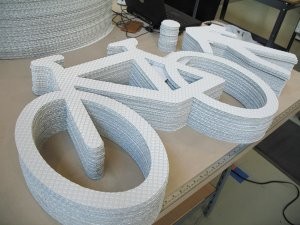 Self-adhering road markings