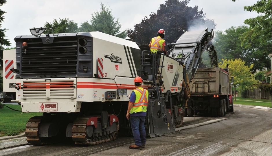 Ground man uses Level Pro control to manage milling depth and cross slope.