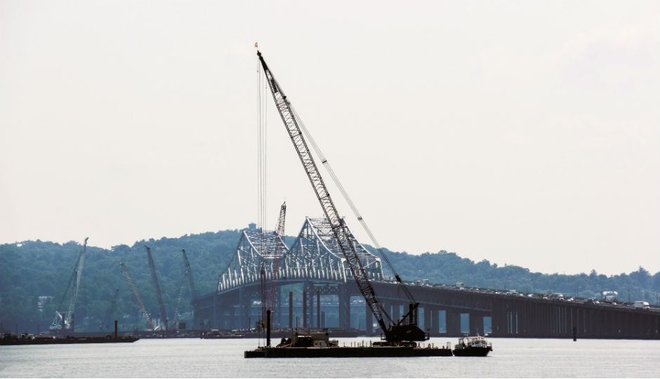 Twin bridge requires 30 cranes to do a wide range of work, including driving piles and sheets, setting concrete, doing form work and casting forms.
