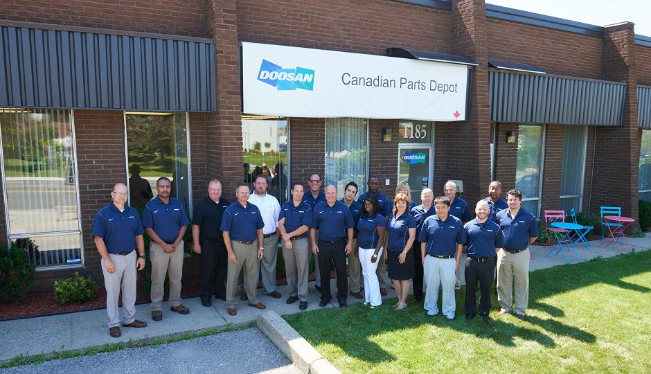 Doosan employees gathered outside to celebrate the opening of the new Canadian parts depot on Thursday, July 16, 2015. The parts depot is located in Mississauga, Ontario, and will serve Doosan customers in Eastern Canadian provinces.