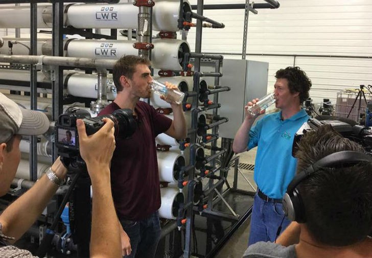 Gareth Jenkins, right, drinks clean water recently recycled from manure through the LWR System with The Water Brothers host, Alex Mifflin.