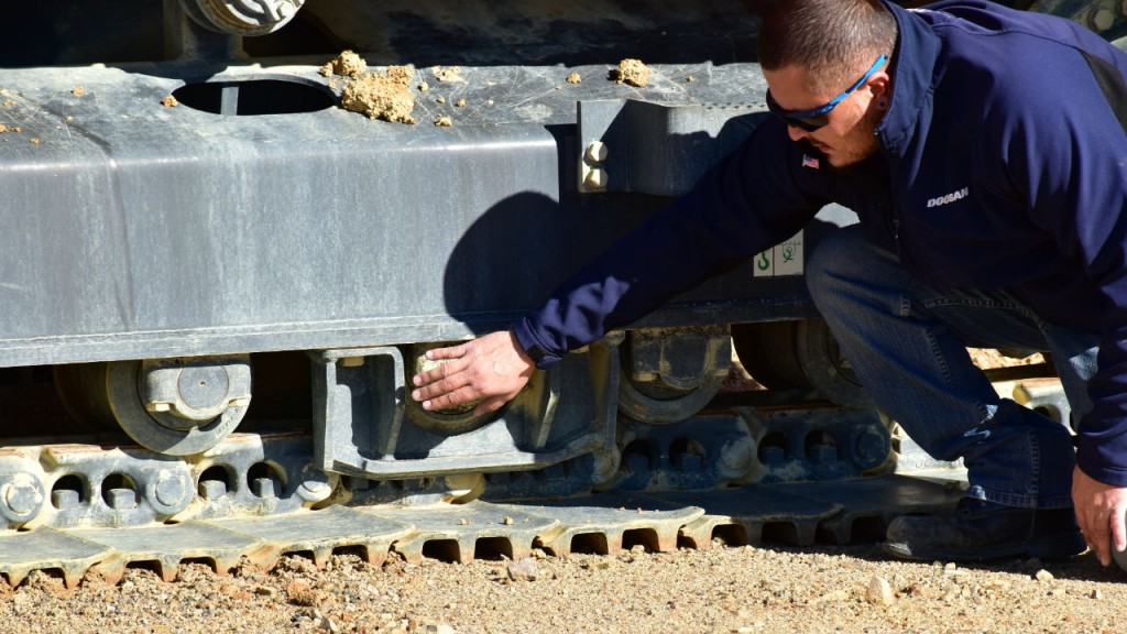 Inspecting material handler roller.