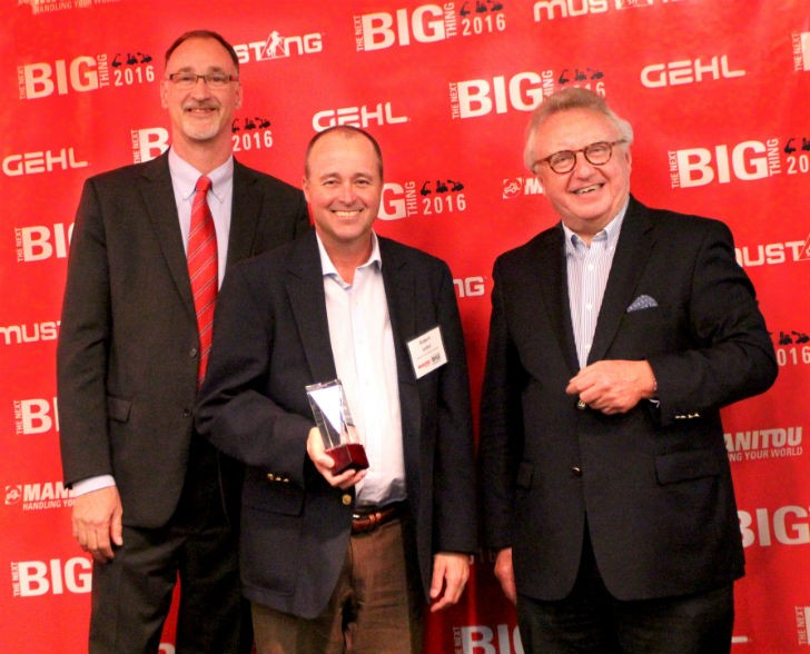 Dan Miller, President & CEO of Manitou Americas, and François Piffard, Executive VP of  Sales and Marketing for Manitou Group, present the 2015 Manitou Top Dealer Award to  Robert Lebel of Hewitt Equipment Limited.