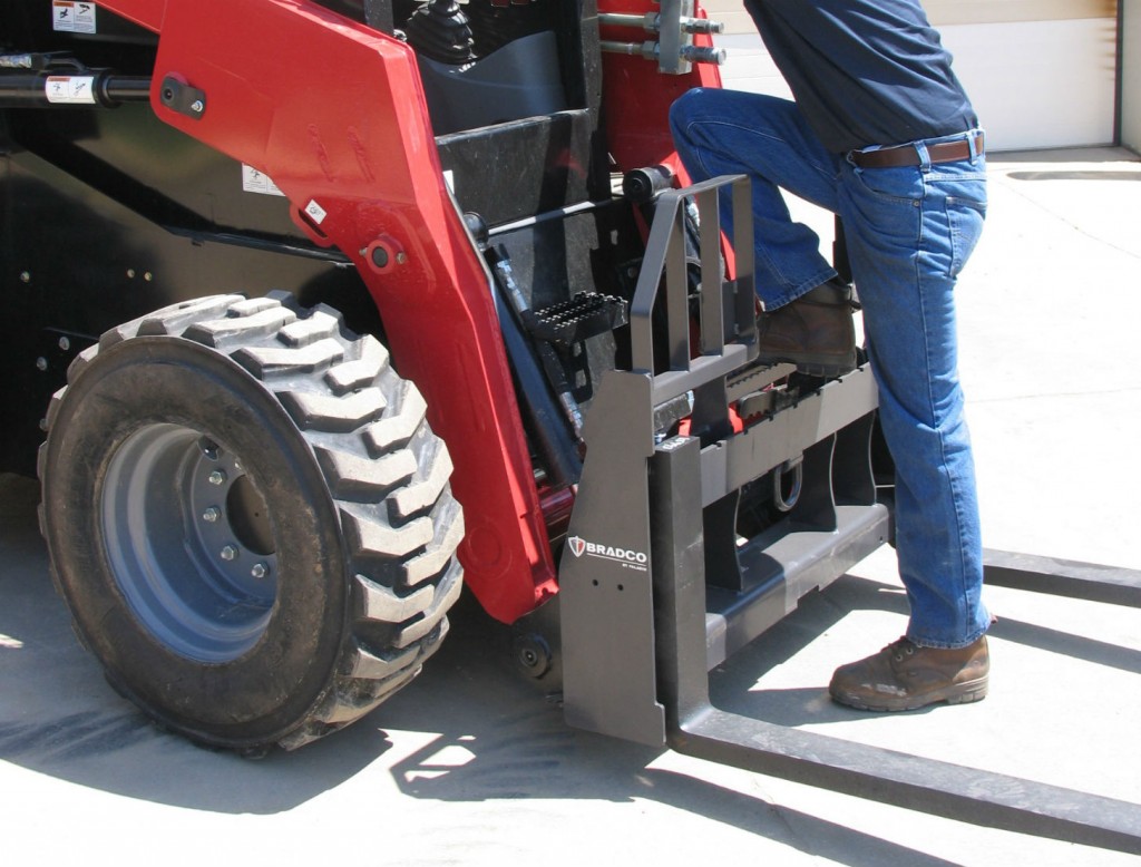 Walk‐Thru Pallet Forks allows the operator to step through the frame upon entry and exit for safe access to the loader.
