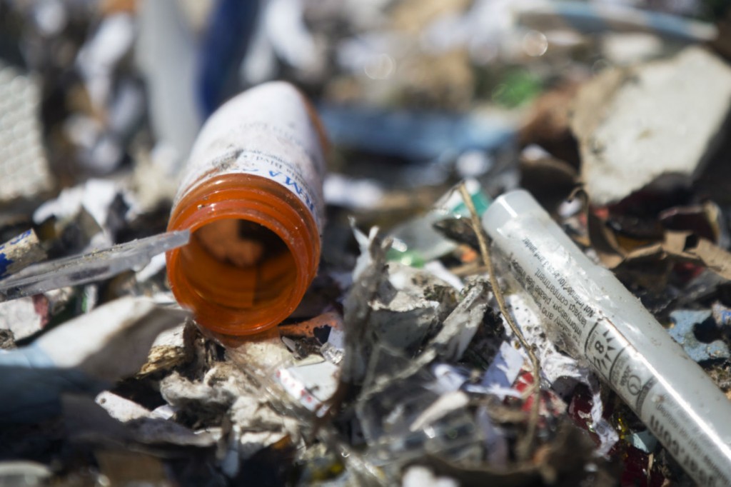 A prescription drug bottle sits inside a bin of recyclables at the Burbank Recycling Center. The Los Angeles County Board of Supervisors is considering an ordinance that would make drug and sharps manufacturers develop and pay for a program to collect and dispose of their unused products. 