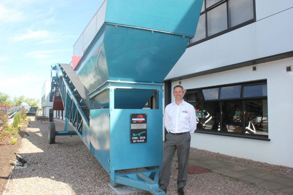 Colin Clements, Global Product Line Director beside a 1966 MK1 screening machine.   This was the sixth machine built and remains a permanent feature at the Dungannon Plant.     