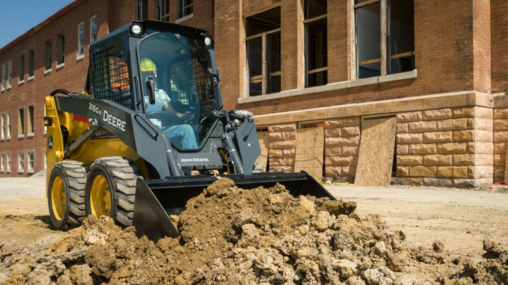 316GR skid steer with grading heel bucket.