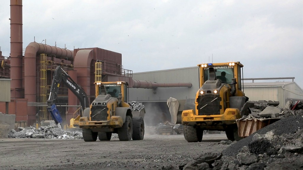 Two Volvo L70H wheel loaders move raw material onsite.