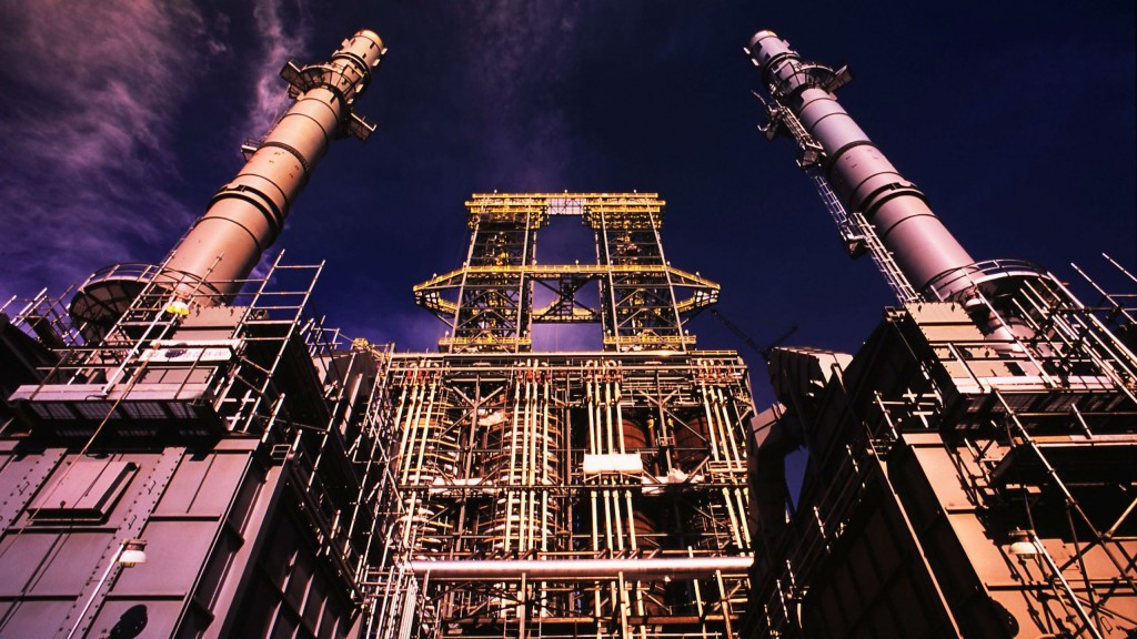 Coker towers at Suncor's oil sands plant; the company hopes to replace two coke-fired boilers with cogen facilities. Coker towers at Suncor's oil sands plant; the company hopes to replace two coke-fired boilers with cogen facilities.