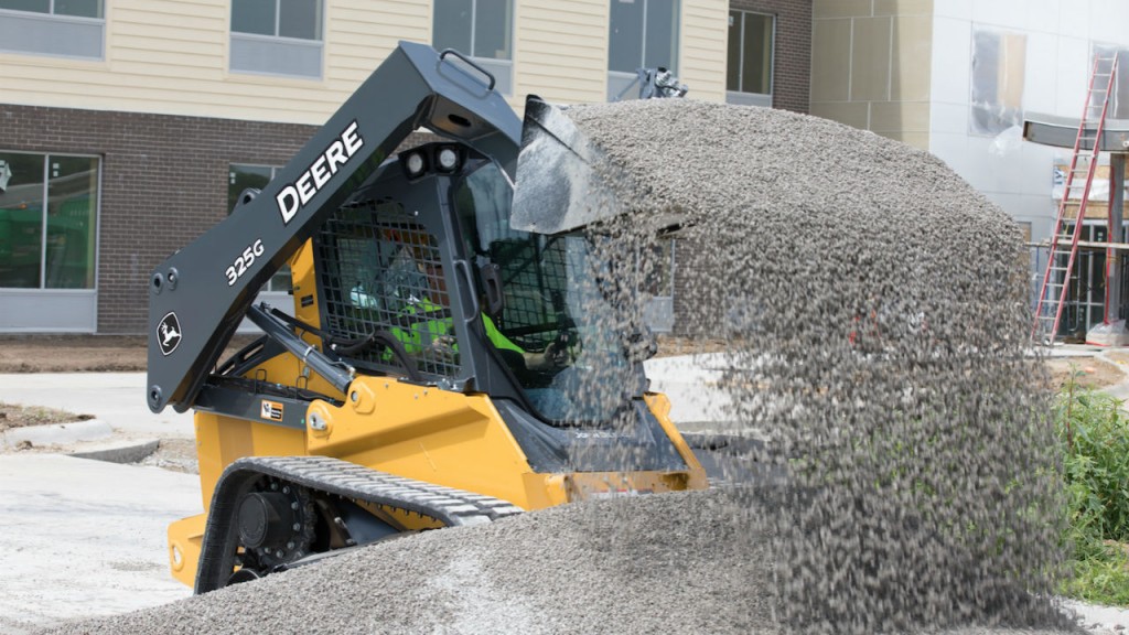 John Deere CTL dumping gravel