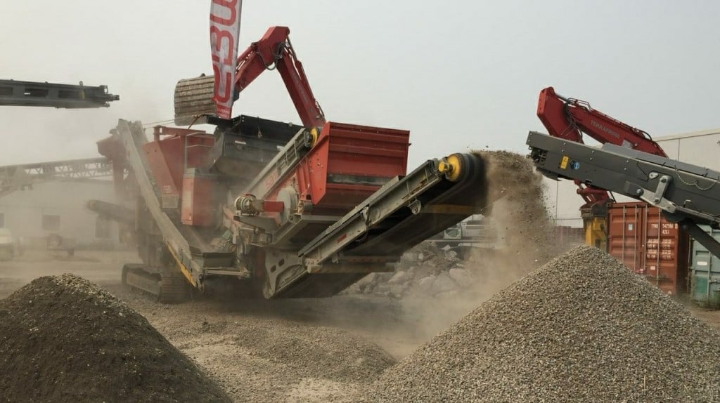 An SBM Remax 1312 mobile impact crusher  in action crushing recycled concrete.