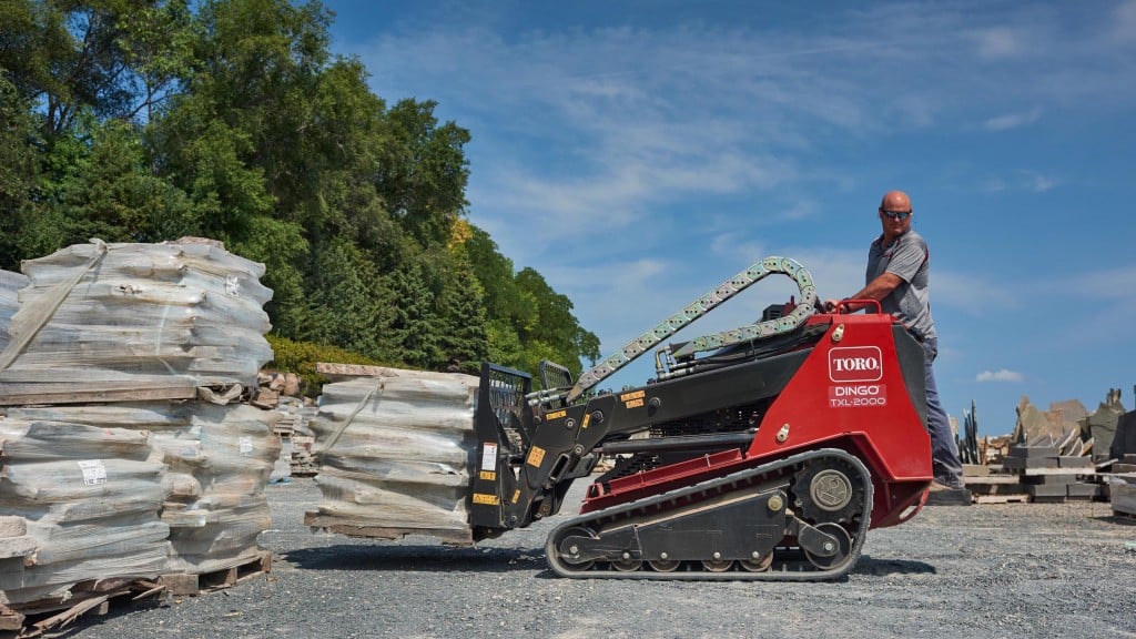 Newest machine boasts innovative telescoping loader arms, 2-ton rated operating capacity.