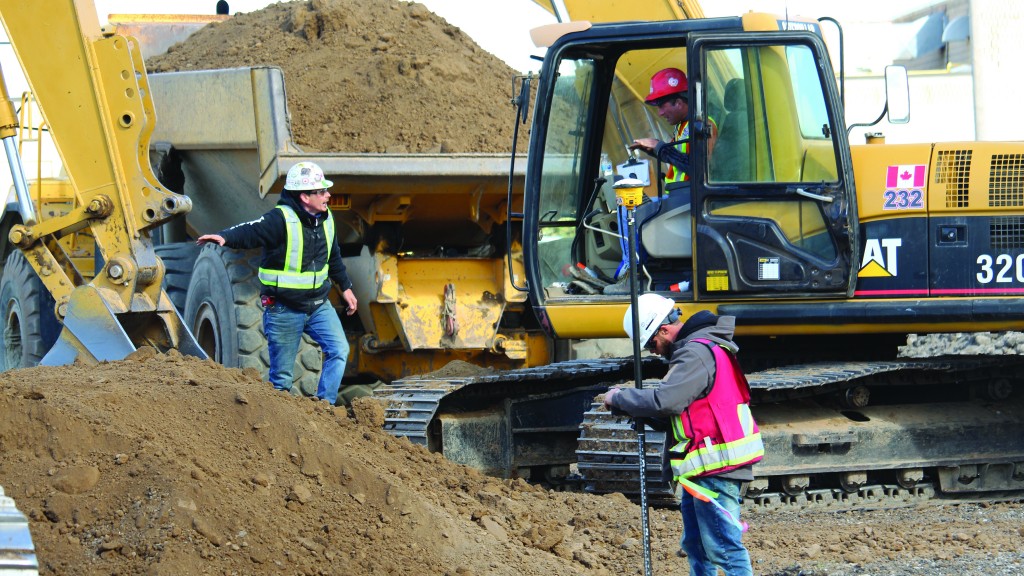 Cat 320C excavator loading a Volvo A30G articulated truck.