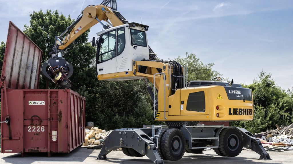 A Liebherr LH 22M material handler loading a container.