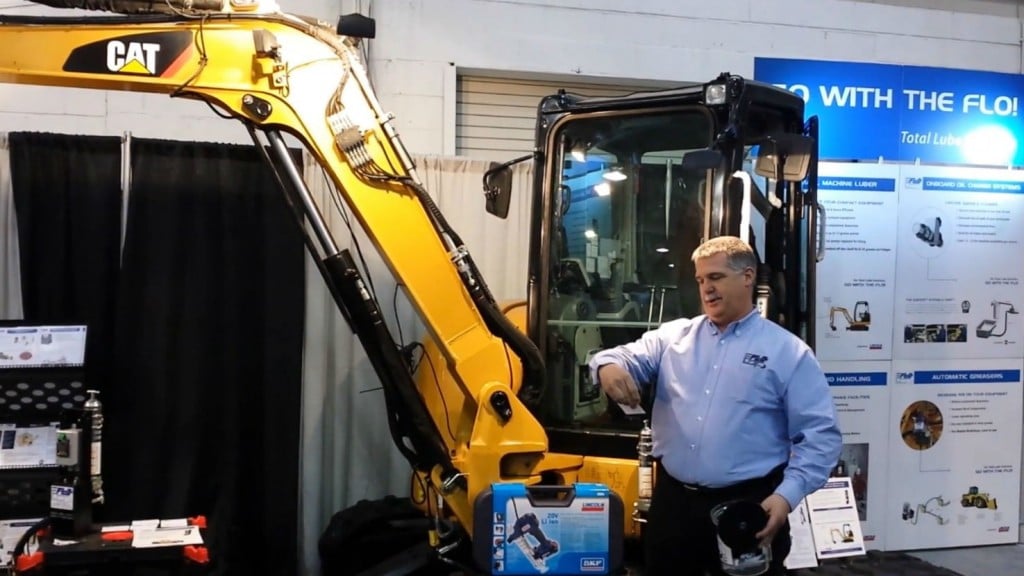 FLO Components vice-president Mike Deckert draws the winner in the company's Lincoln PowerLuber grease gun contest at the National Heavy Equipment Show 2019.