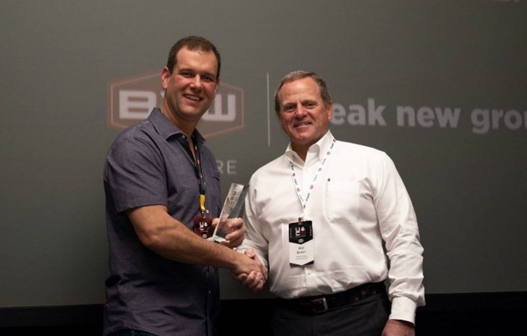 Bob Brown, right, president of B2W Software presents the B2W Software 2019 Client Innovation Award for Best Use of the B2W ONE Platform to Ryan Priestly, president of Priestly Demolition.