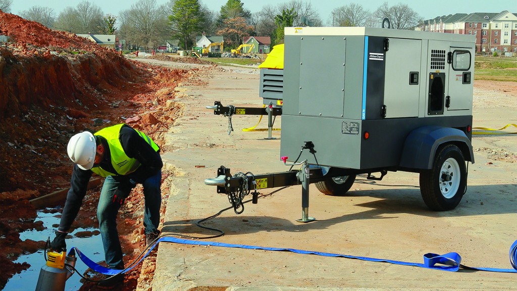 An Atlas Copco generator powers a pump.