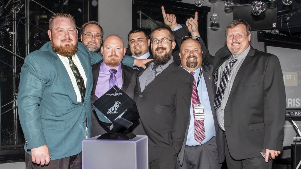 7 men in suits accepting an award.