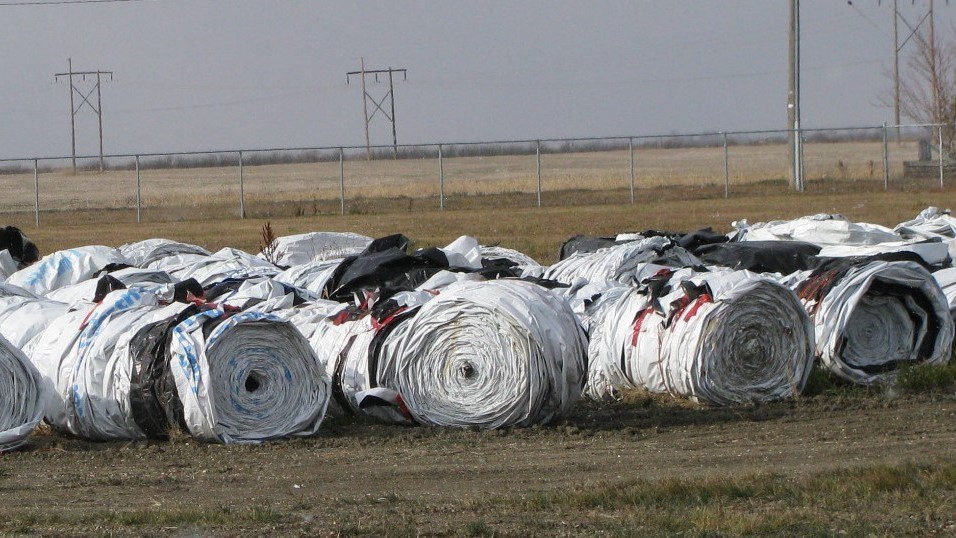 Rolled grain bags at a Saskatchewan Cleanfarms collection site ready to go to an end market to be washed, shredded and pelletized, and then recycled into new plastic bags.