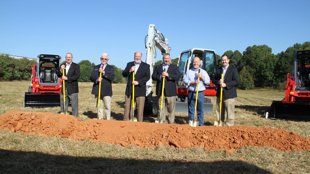 Men with shovels break ground