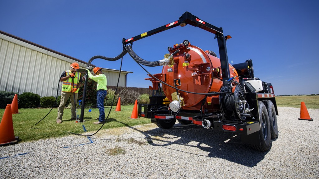 Ditch Witch HX30G vacuum excavator operated by two men