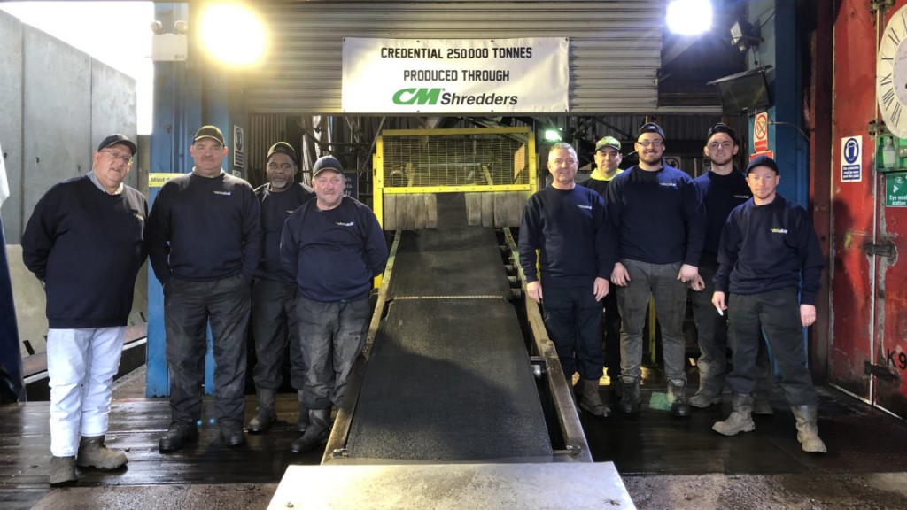 men pose for picture to celebrate recycling milestone