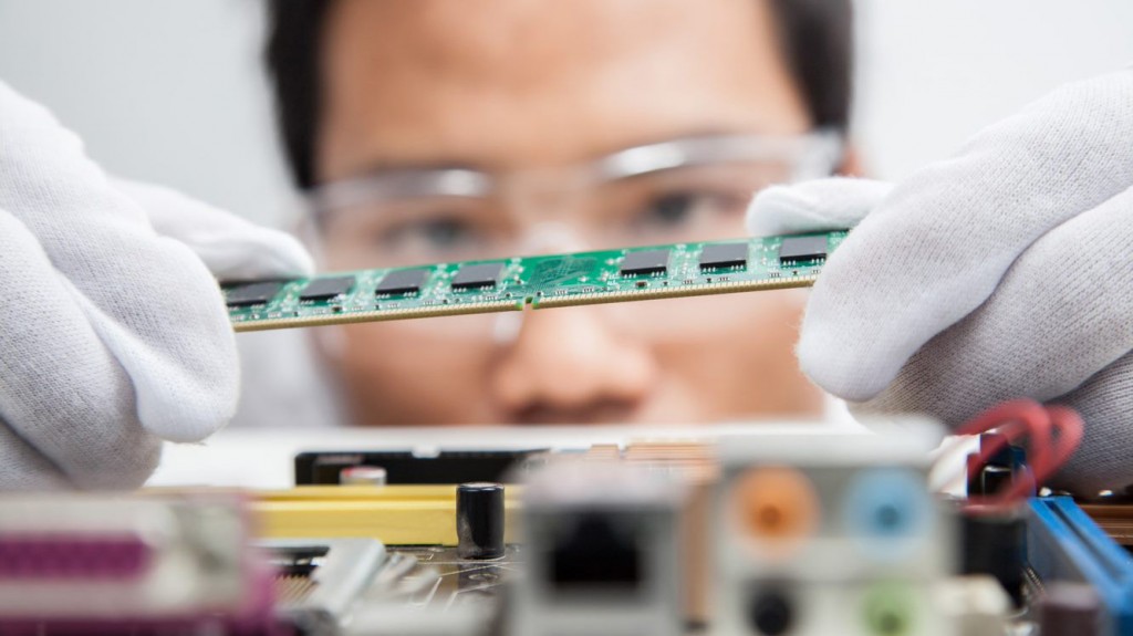 a man looks to place a circuit board