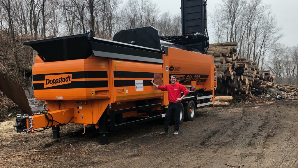 man stands next to doppstadt machine