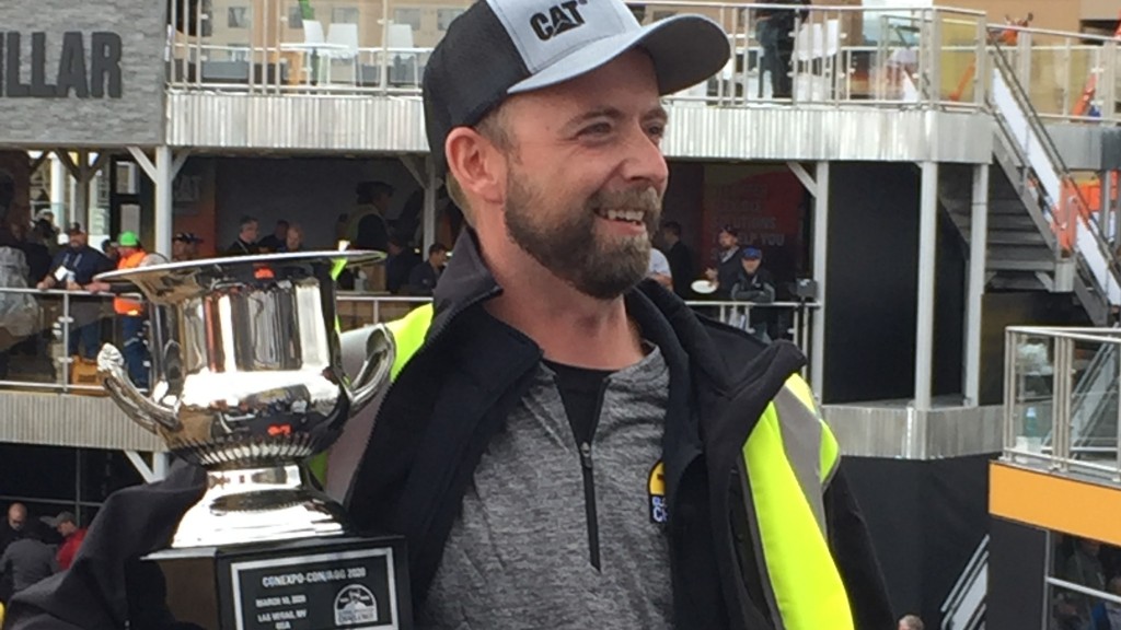 Operator Jaus Neigum holding championship trophy