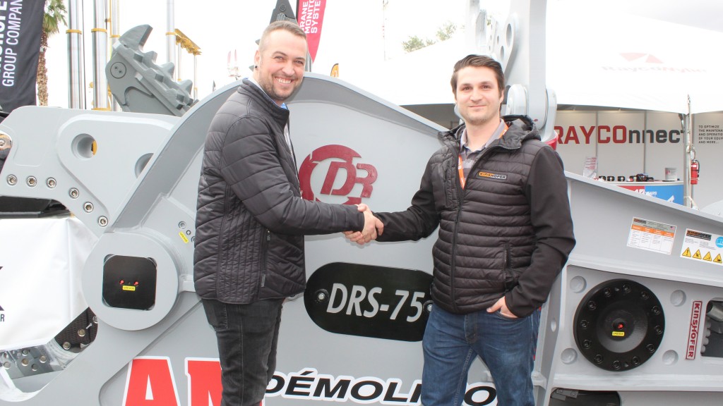 two men shake hands in front of Kinshofer scrap shear