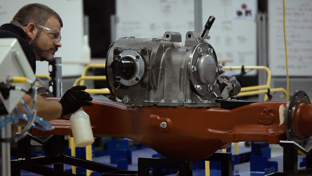 man cleaning a Mack axle