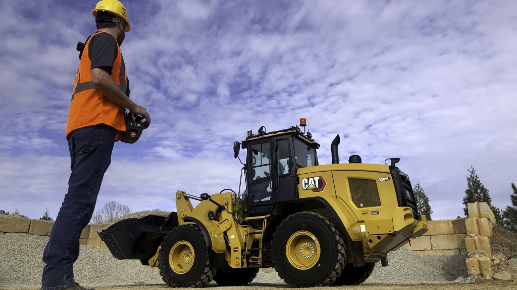 man performs action on cat command to control wheel loader