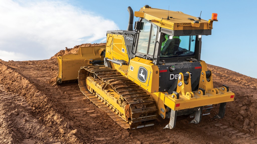 john deere 700L crawler dozer moving over a hill