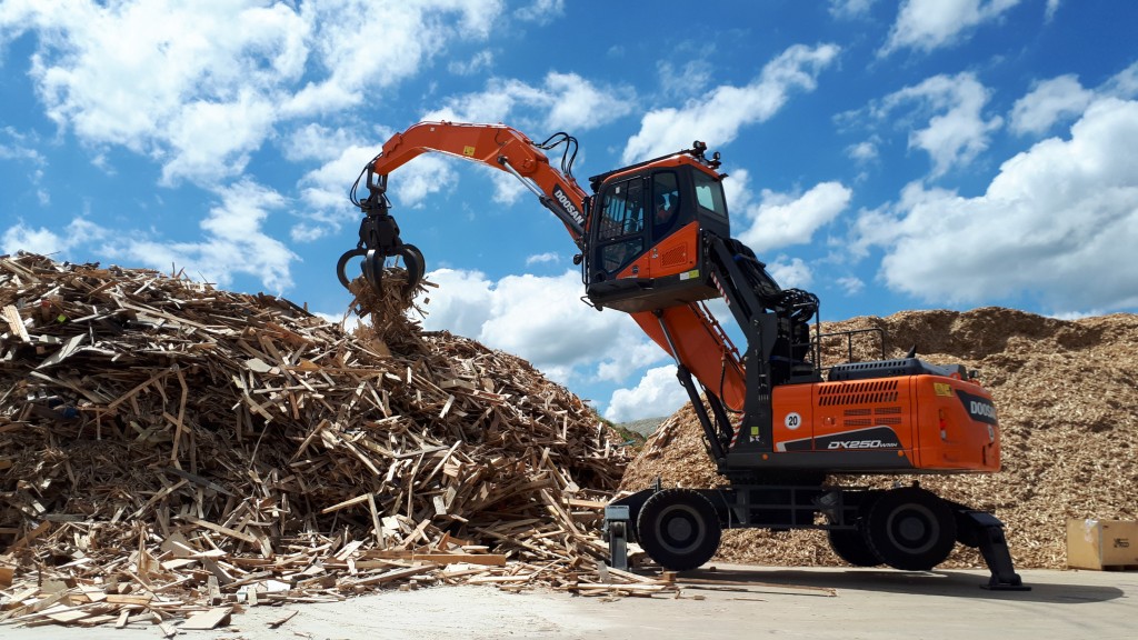 Doosan DX250WMH-5 wheel material handler at waste wood pile