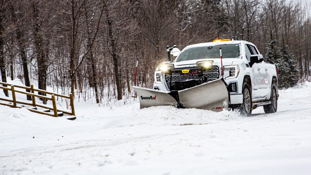 Snow plow plowing snow on the road