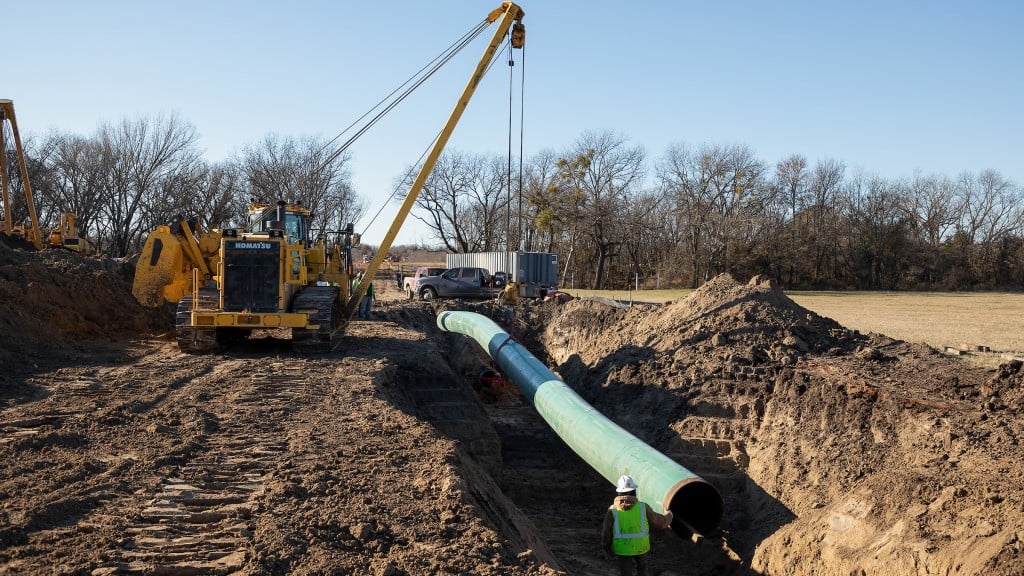 D155CX-8 pipelayer laying pipe in a trench