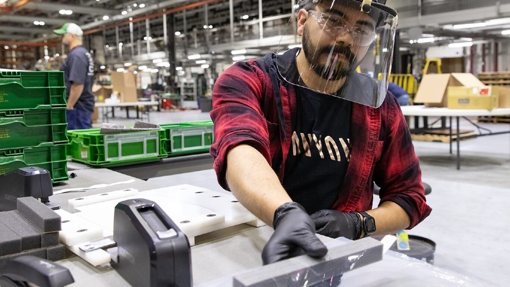 John Deere Seeding Moline assembler Jose Martinez assembles face shields for health care workers.