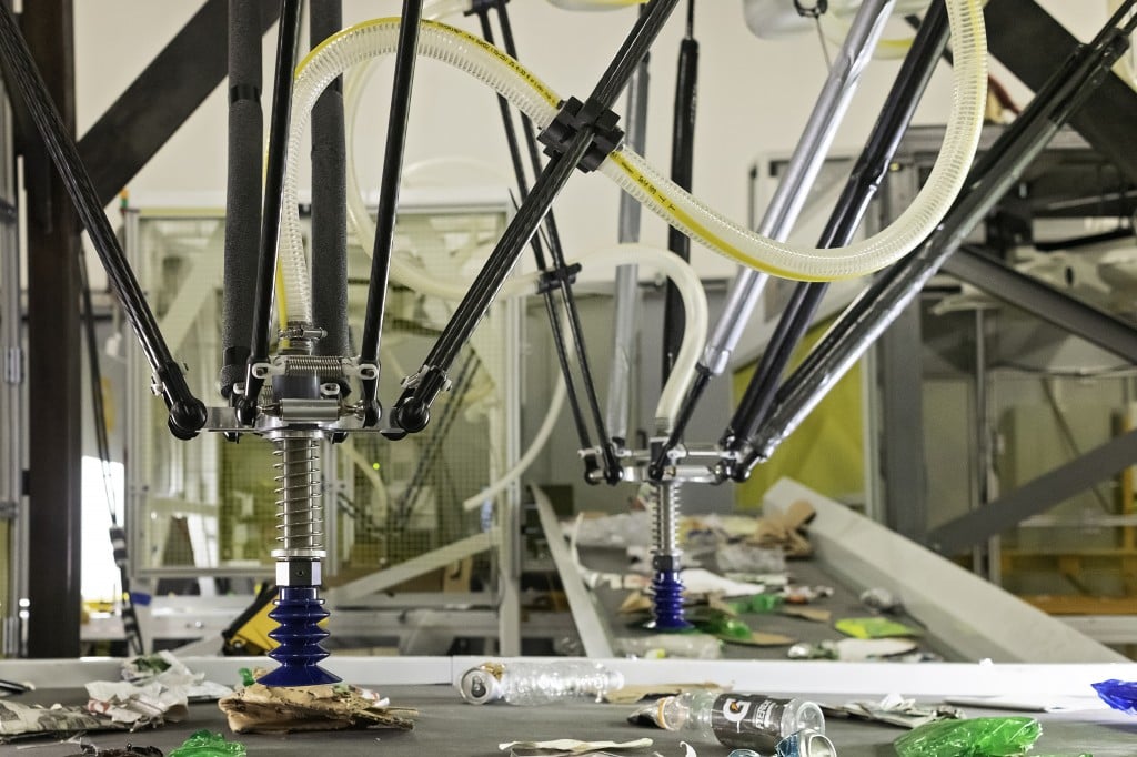 recycling sorting machine picks up pieces of plastic