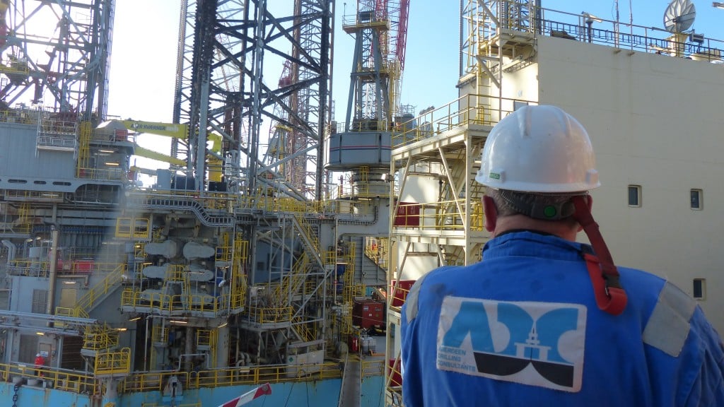 Aberdeen drilling consultant worker looks at tanker Aberdeen drilling consultant worker looks at tanker