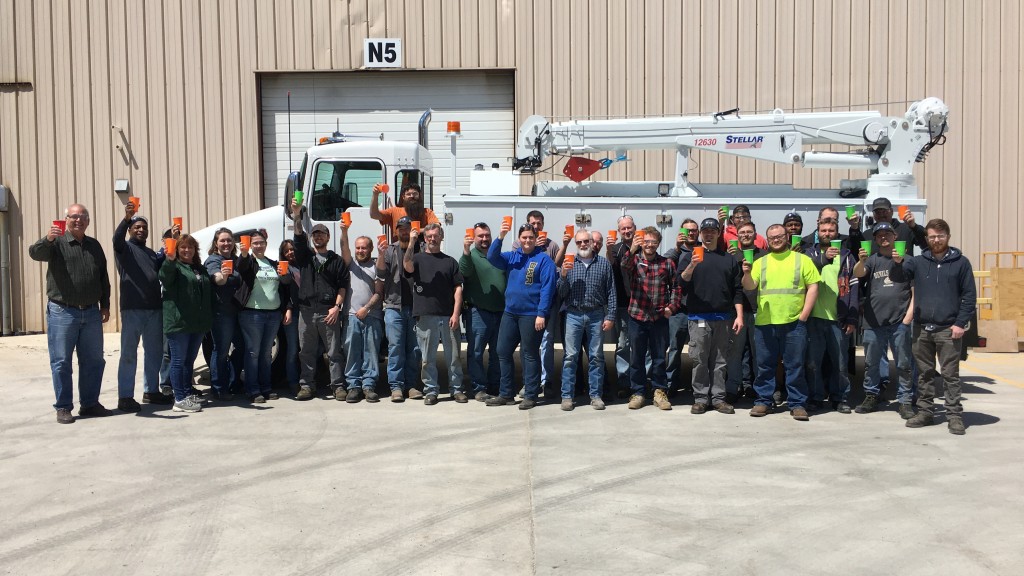 The Stellar team celebrates in front of one of their trucks