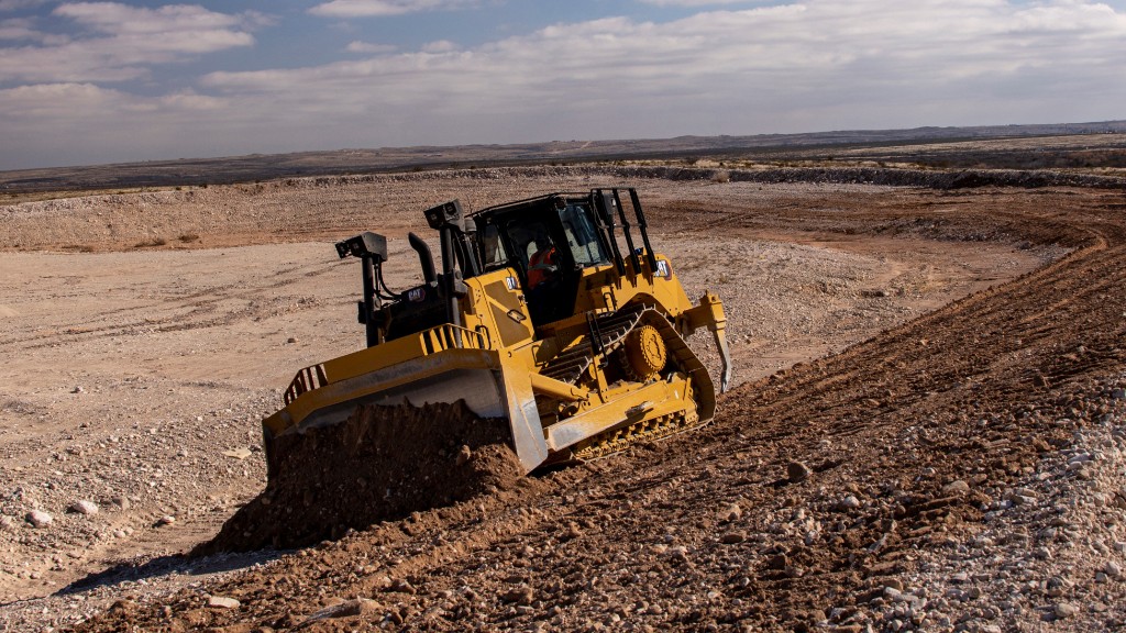 Cat D7 dozer pushing dirt on a work site.