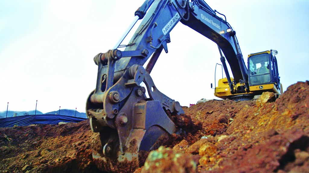 worker operates a machine in a worksite