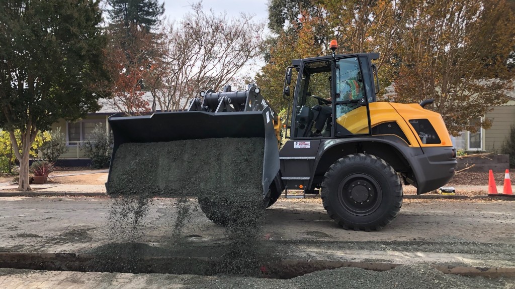 Mecalac swing loader spreading graval